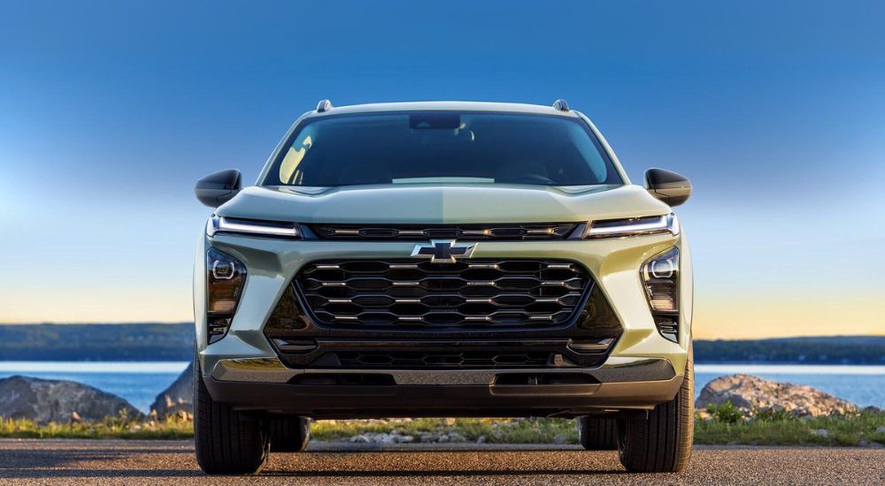 A green 2025 Chevy Trax ACTIV is shown parked on a sunny day.