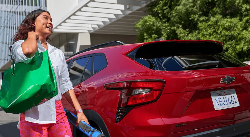 Woman walking past a 2026 Chevy Trax RS