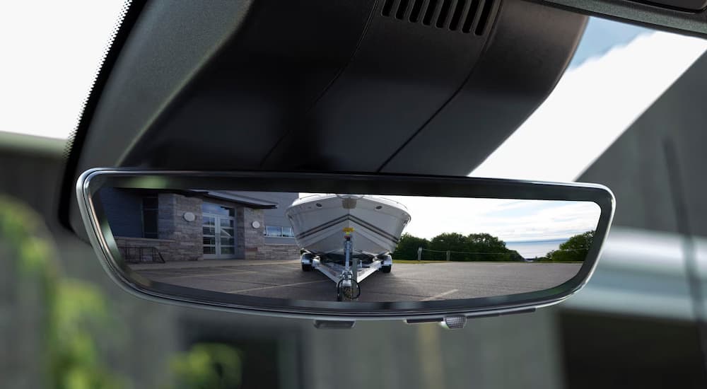 Boat on a trailer in the rearview mirror of a 2026 Silverado 3500 HD