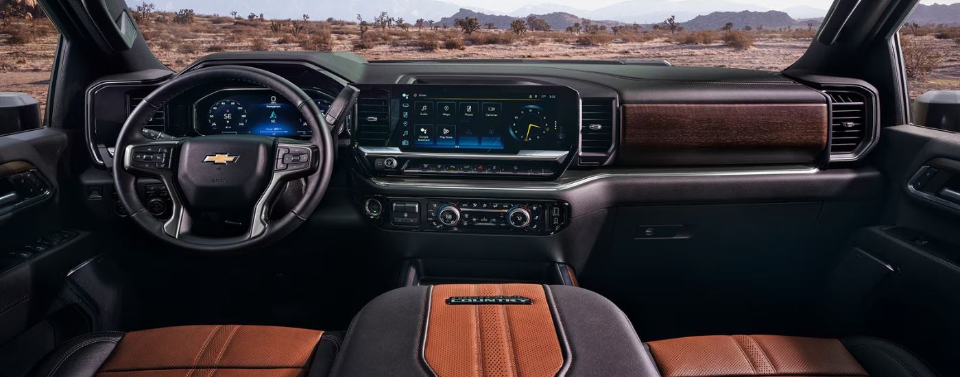 Interior view of a 2026 chevy Silverado 2500 HD infotainment, steering wheel and digital gauge cluster.