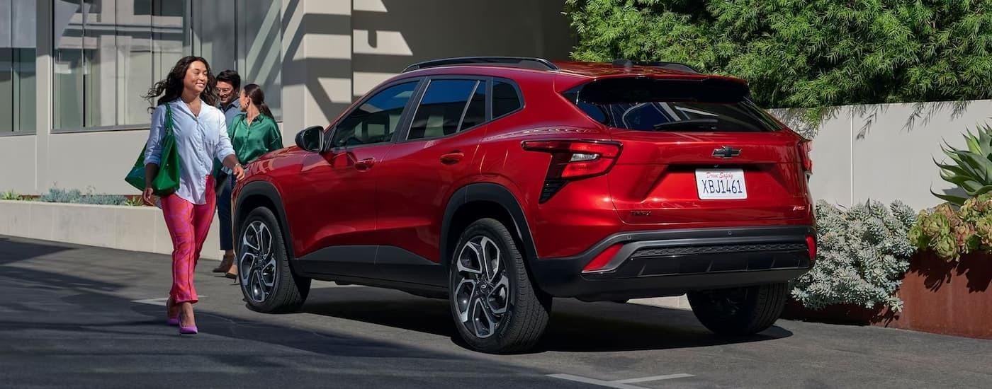 Side and rear of a red 2026 Chevy Trax parked on the side of a street