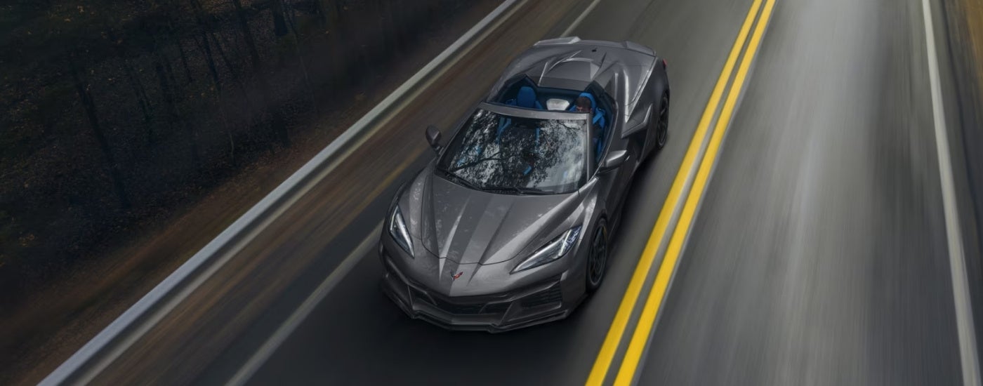 Grey 2025 Chevy Corvette E-Ray driving on a highway