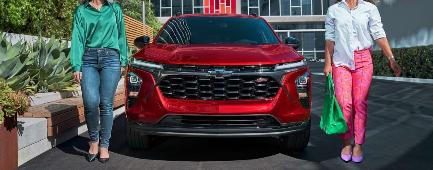 Front of a red 2026 Chevy Trax RS parked in a city