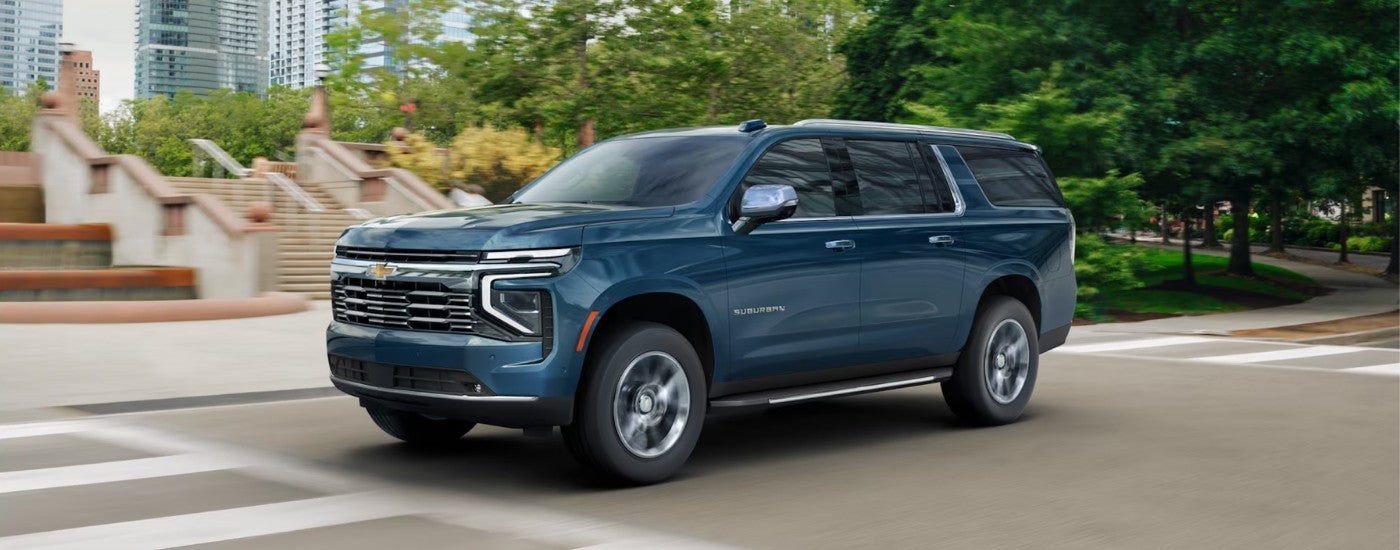 Blue 2026 Chevy Suburban driving on a city street