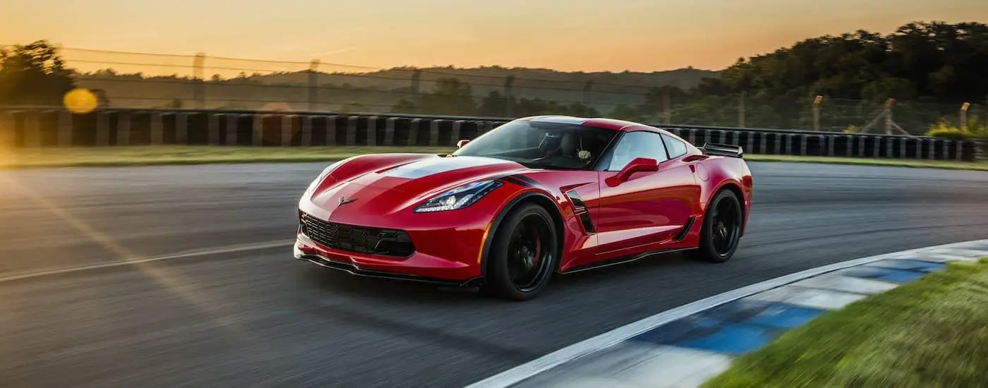 A red 2017 Chevy Corvette Grand Sport Z07 on a race track after visiting a certified pre-owned Chevy dealer.