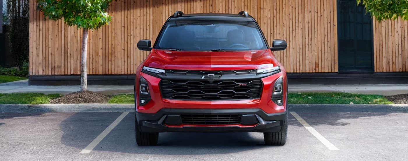 A red 2025 Chevy Equinox RS parked in a parking lot.