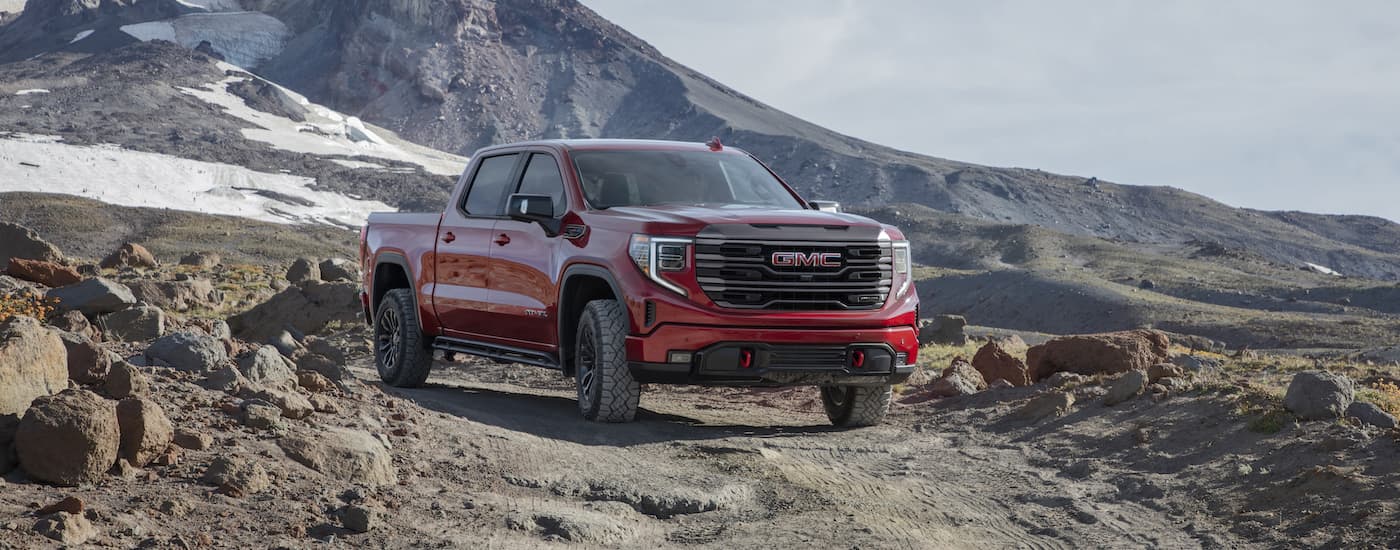 A red 2022 GMC Sierra 1500 AT4x is shown from the front at an angle.