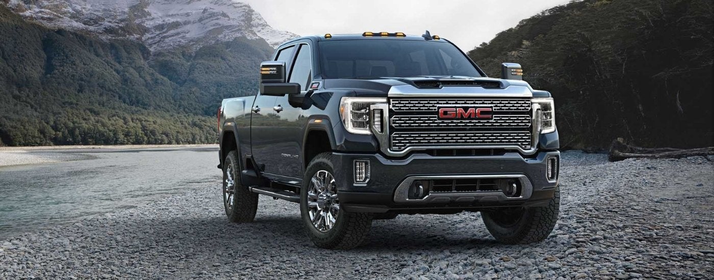 A gray 2023 GMC Sierra 3500 HD is shown parked off-road.