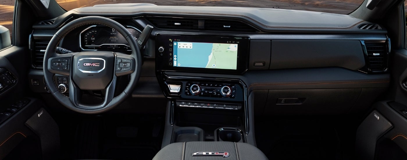 The black interior and dash of a 2024 GMC Sierra 2500 HD AT4 is shown.