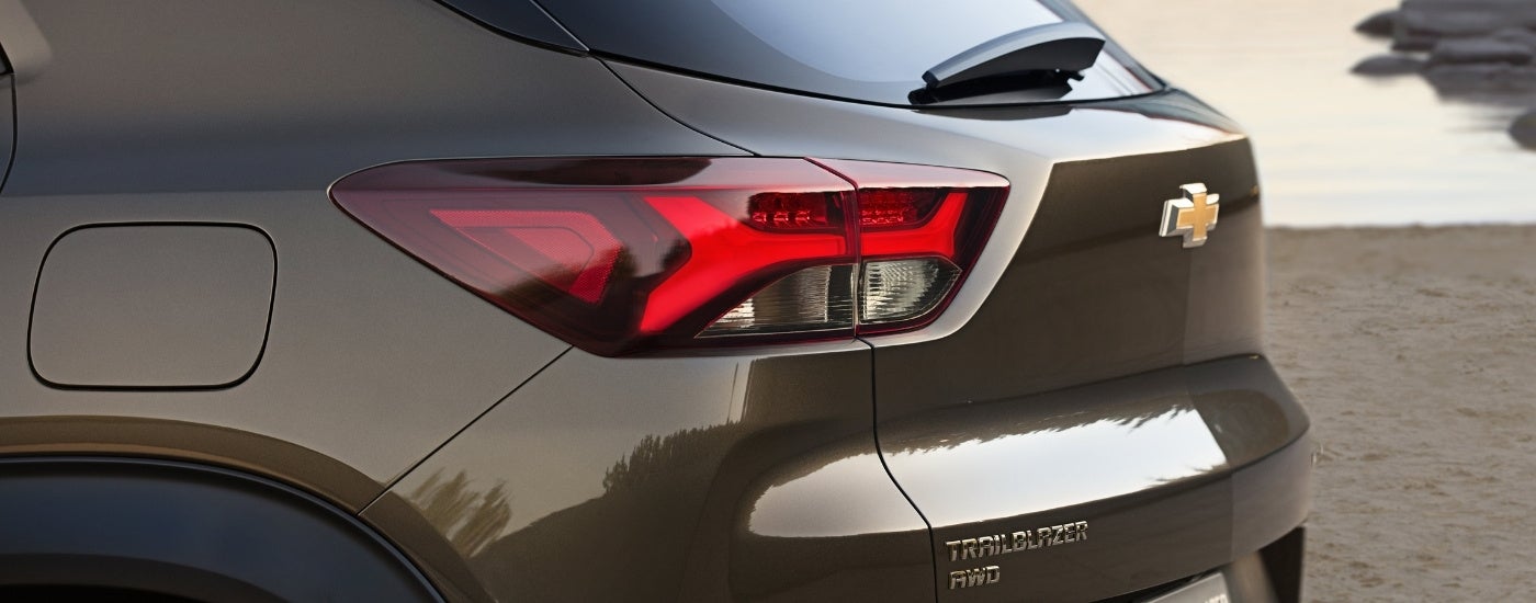 A close-up shows the driver side taillight on a brown 2021 Chevy Trailblazer ACTIV.