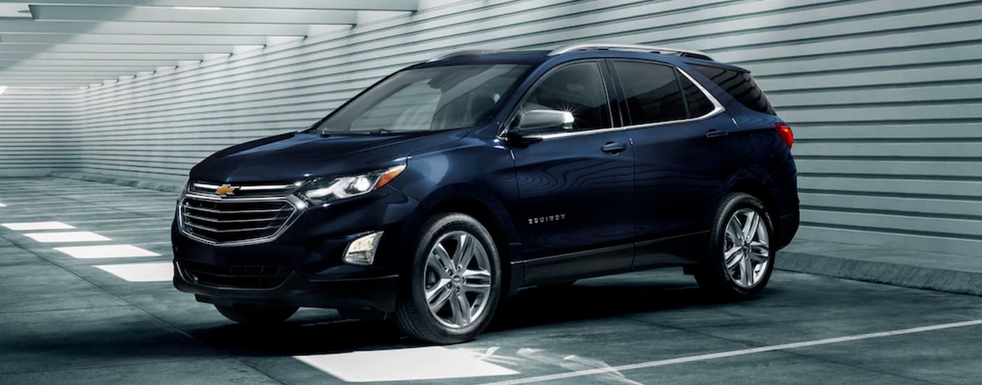 A dark blue 2021 Chevy Equinox parked in a parking garage.