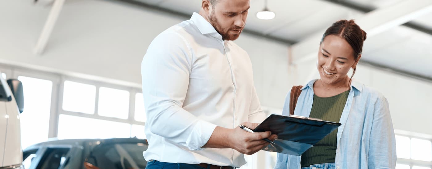 A salesman is speaking to a customer about how to value their trade.